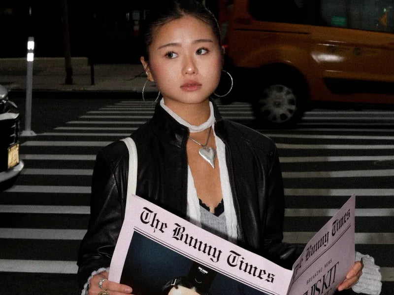 Rebel Bunny in New York holding the pink Bunny Times newspaper