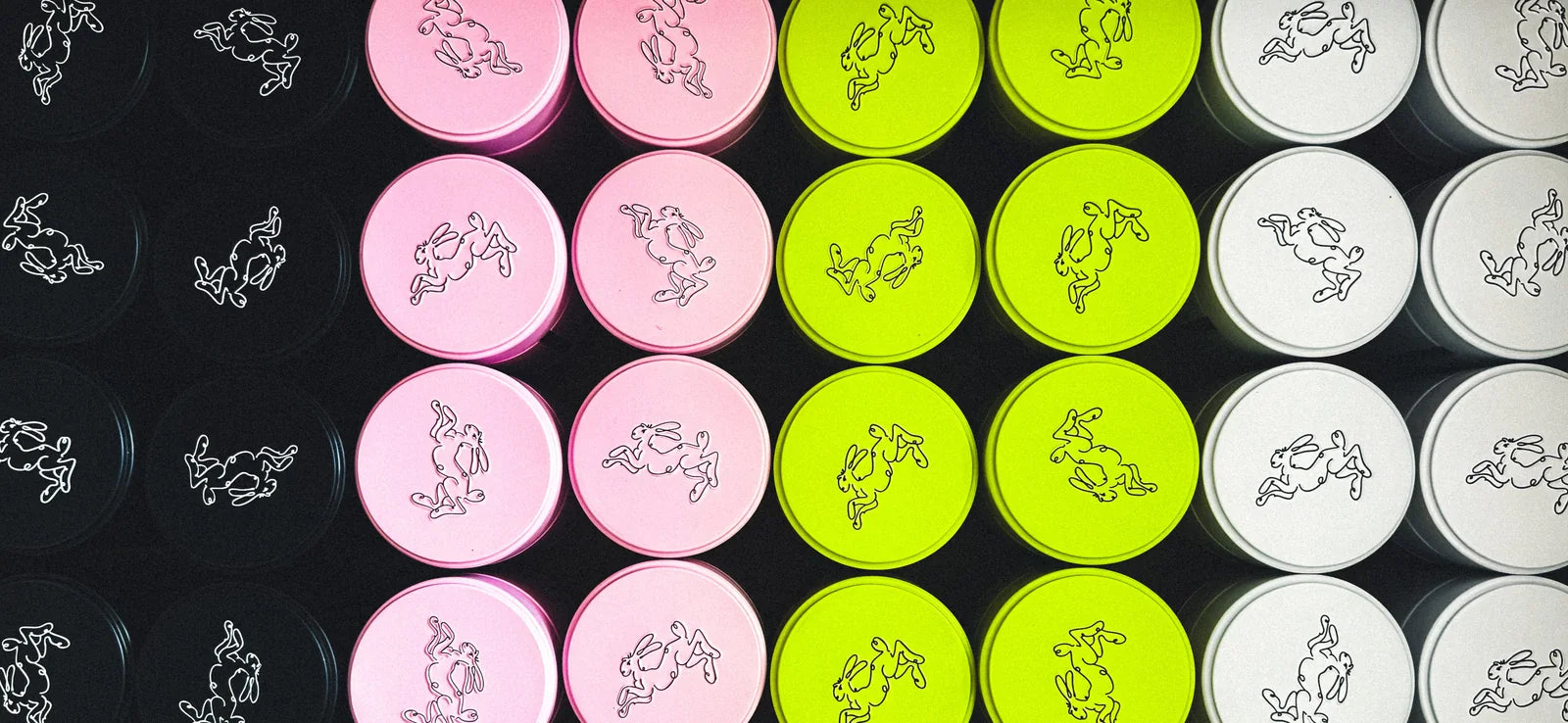 Rebel Bunny matcha tins in black, pink, acid green, and white